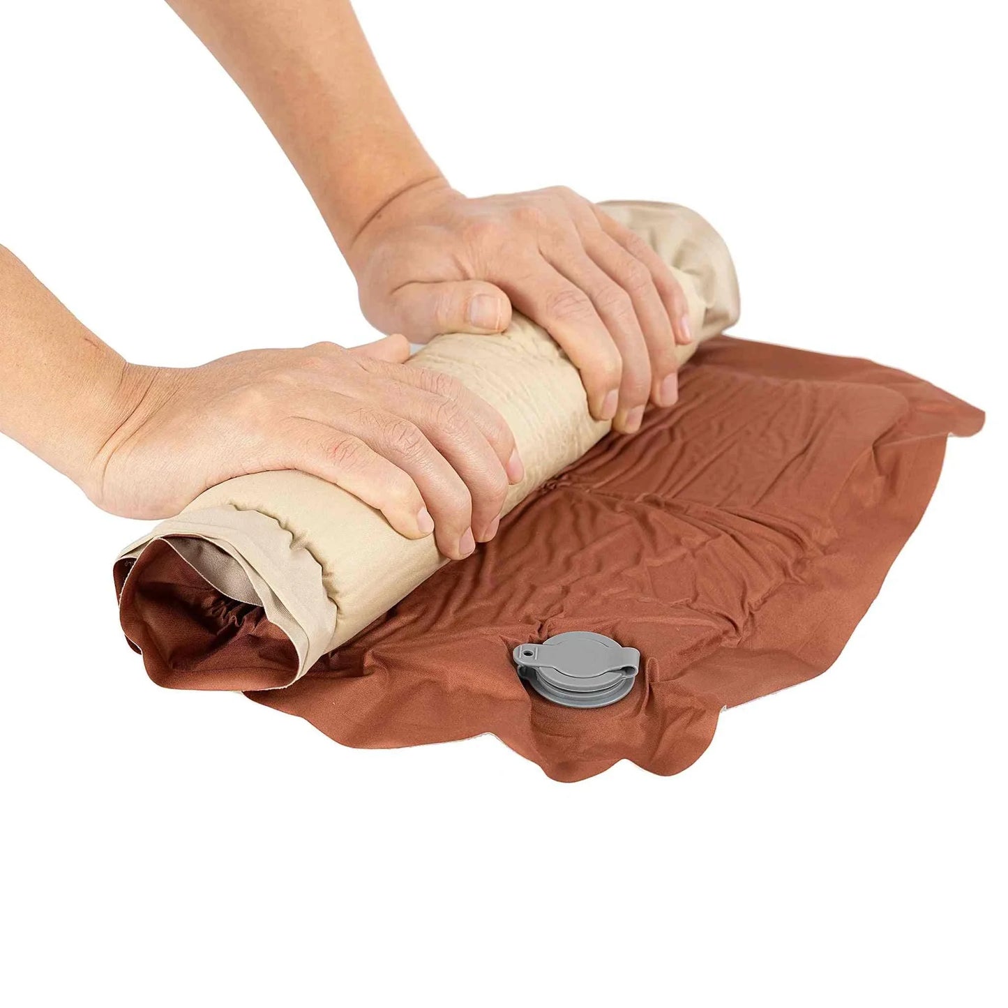 Inflatable pillow being rolled up for easy transport.
