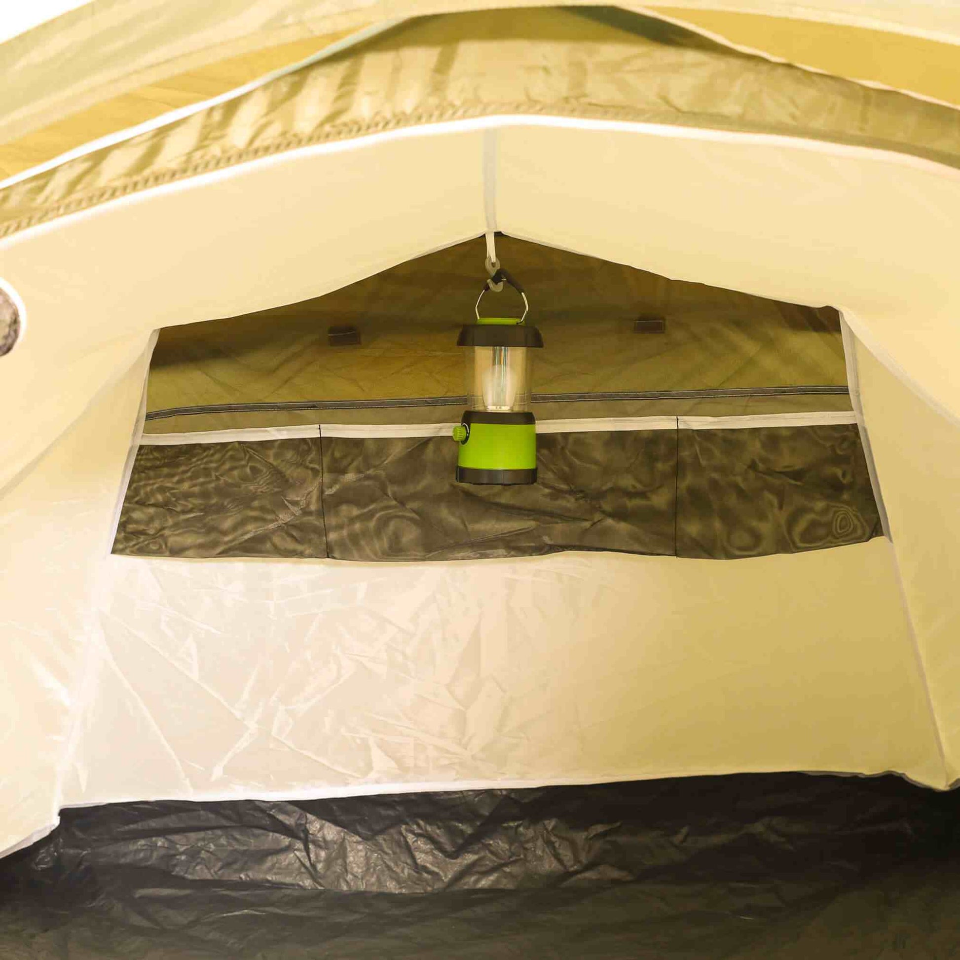 2-person pop up tent interior with light hanging, showcasing durable seams and ventilation features.